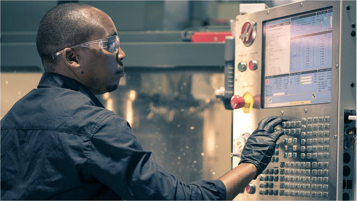 Man programming CNC machine.