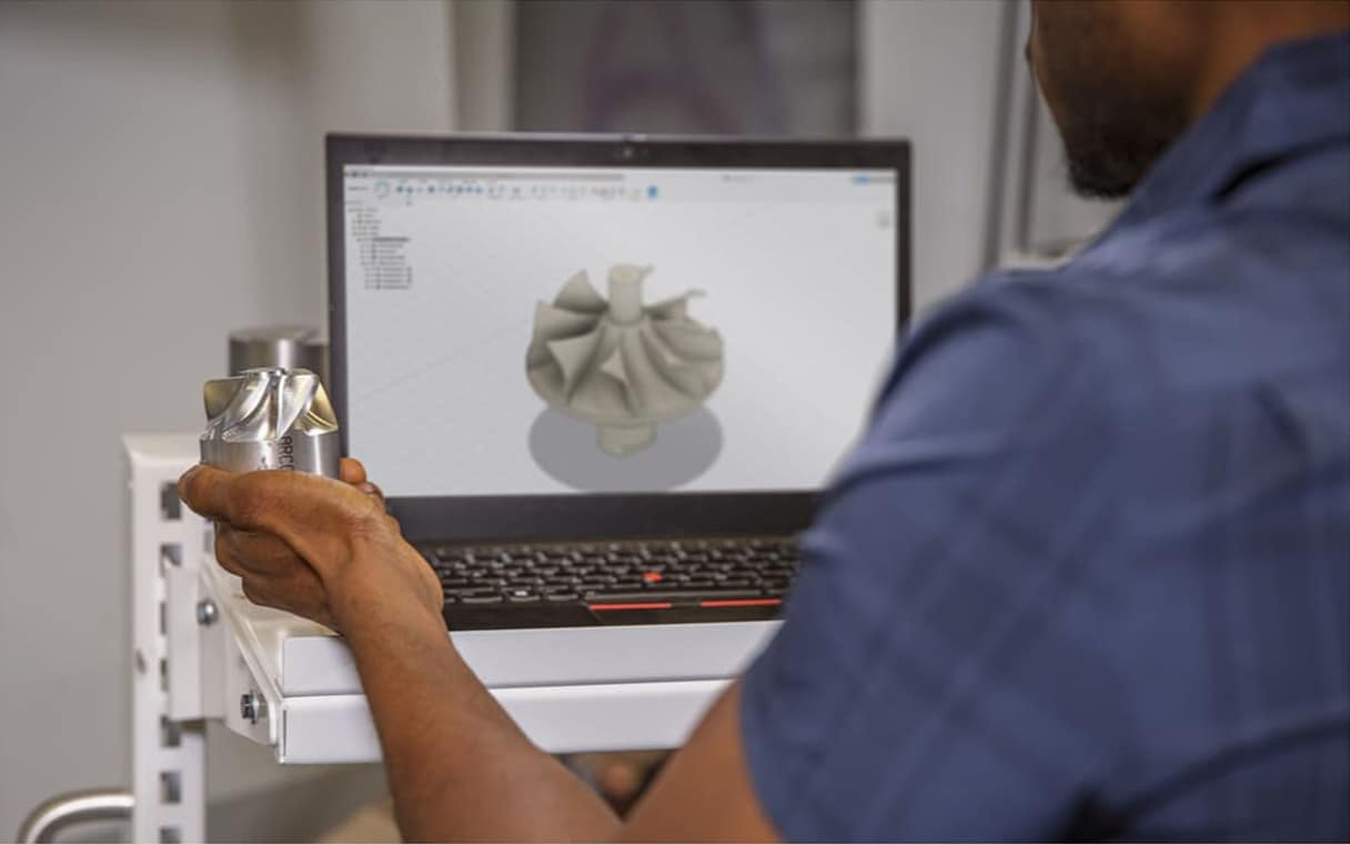 Student using Fusion 360 in CNC lab.