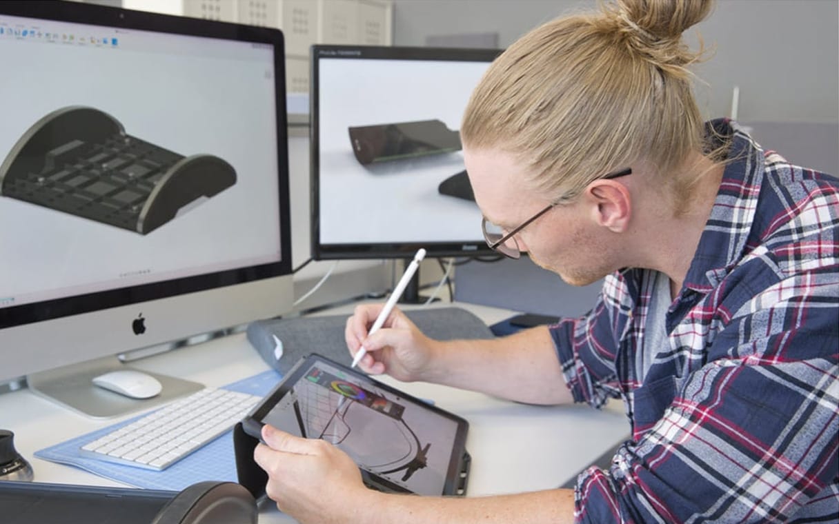 Man sketching on a tablet using Fusion 360.