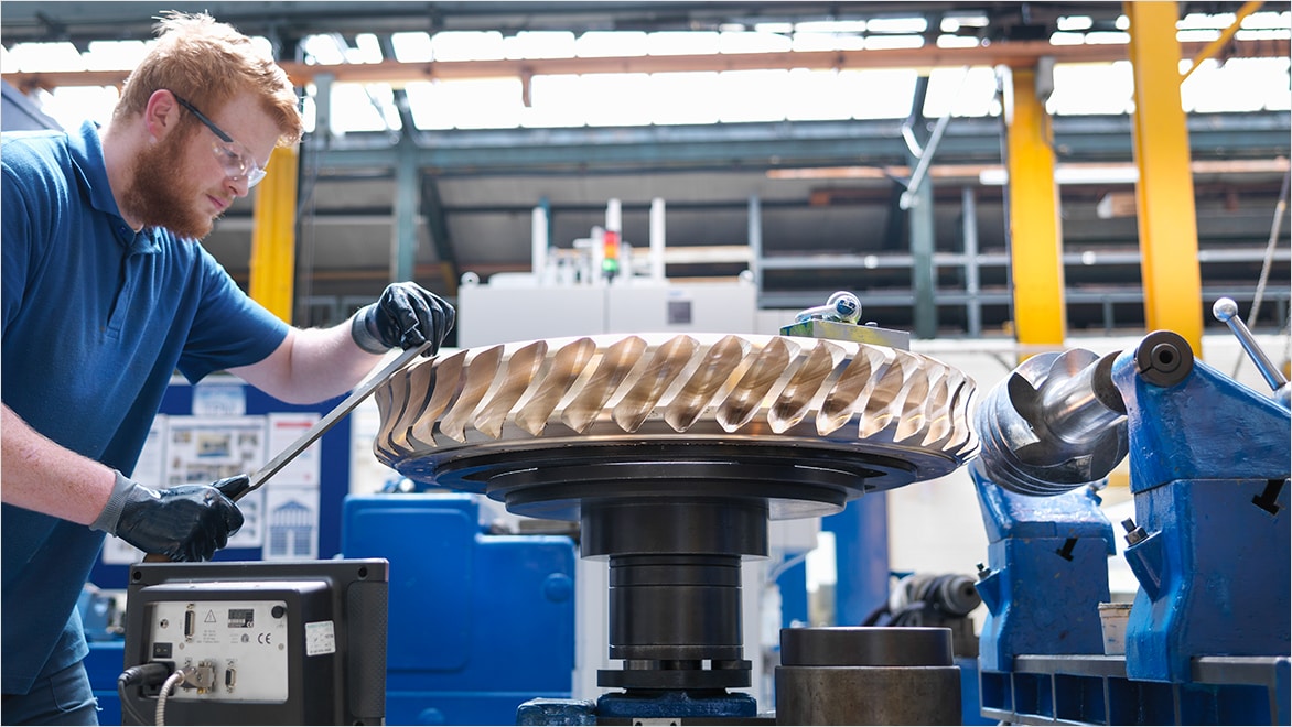 Man removing burrs from a machined part.