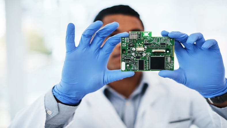 Man verifiying an electronic circuit board