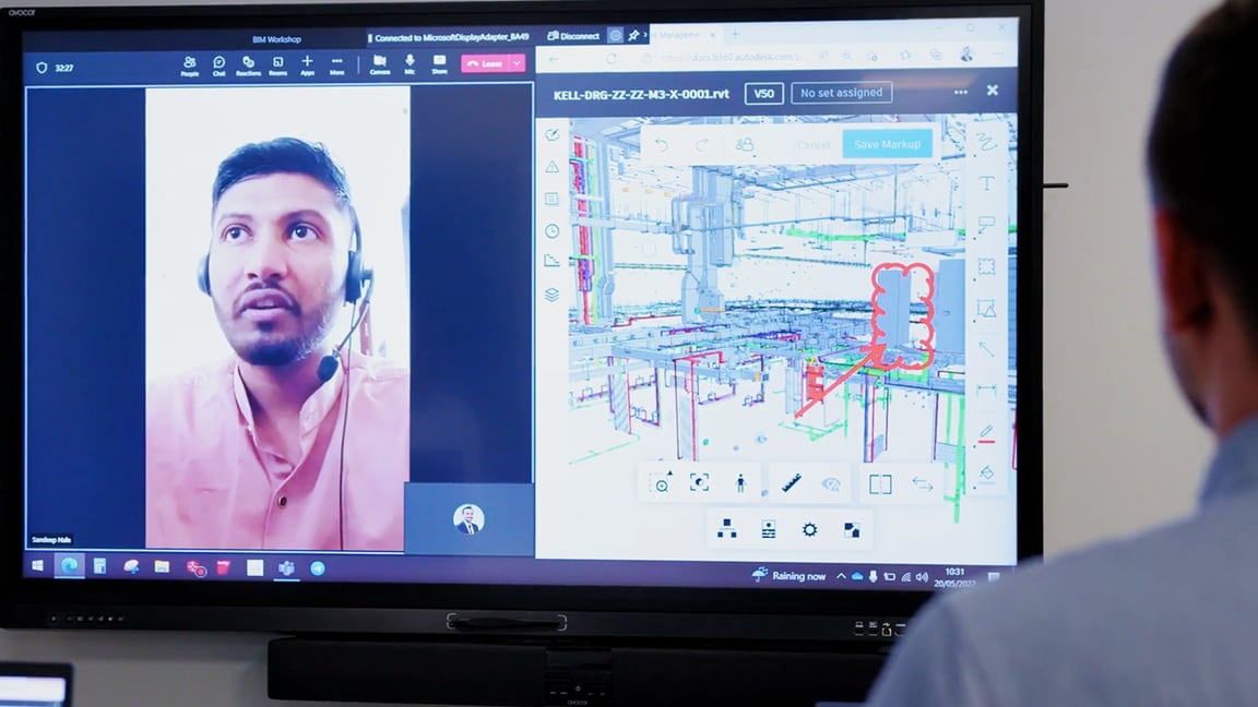 Person collaborating with design model and colleague on screen