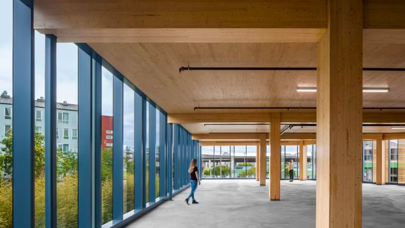 Open space with timber columns and wall-to-ceiling windows