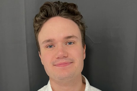 Headshot of Adam Peterson, Vartega's Marketing Communications Specialist, smiling, wearing a white shirt.