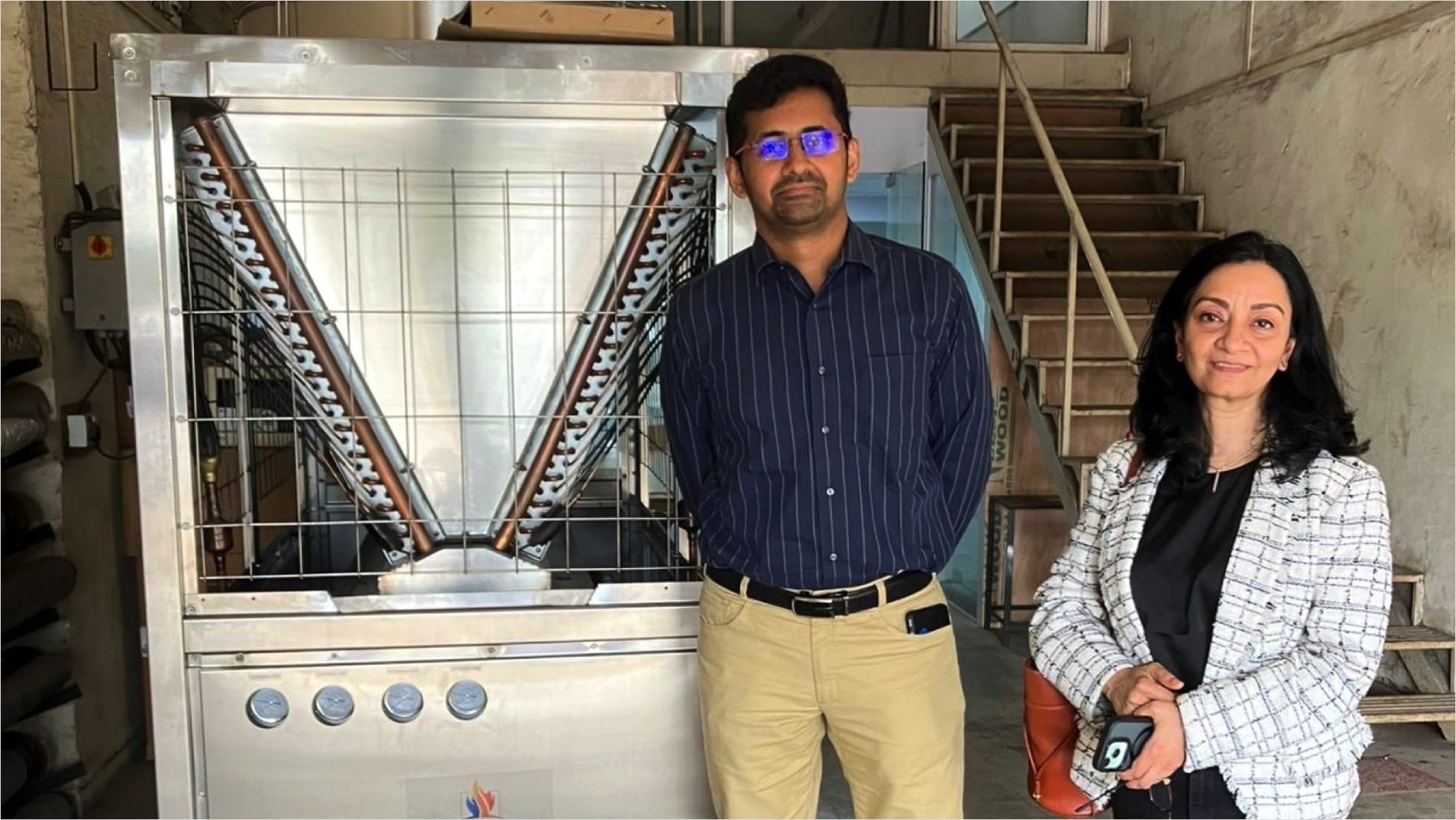 Ashwin KP (Promethean Energy, left) and Ruchira Shukla (Synapses, right) next to one of Promethean Energy's newly assembled heat pumps.