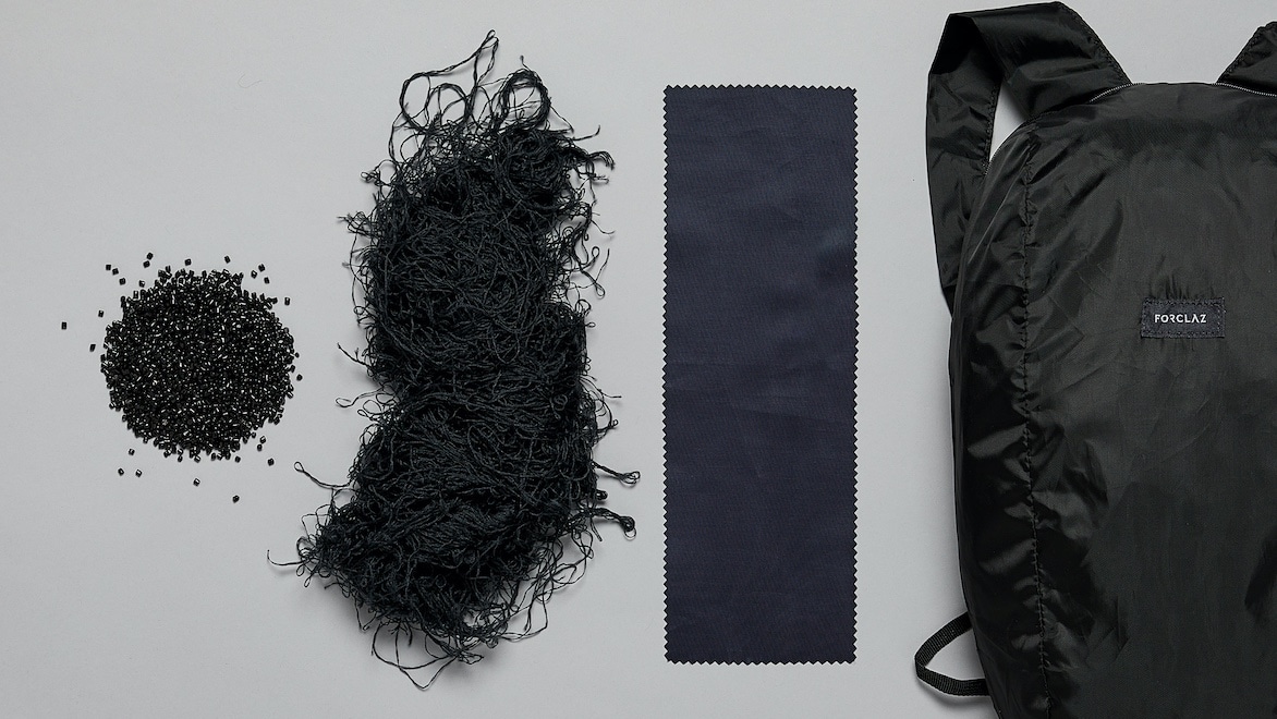Progression showing small plastic pellets, recycled polyester yarn made from recycled plastic, recycled polyester fabric, and a backpack made of recycled polyester fabric.