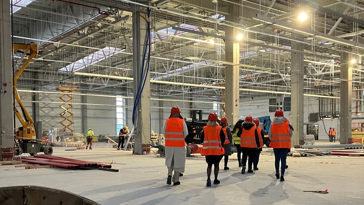 visitors tour the Legnica factory construction site