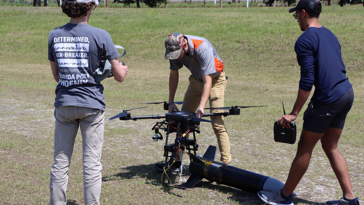 Luna and teammates prepare the first rocket prototype to takeoff attached to a drone.