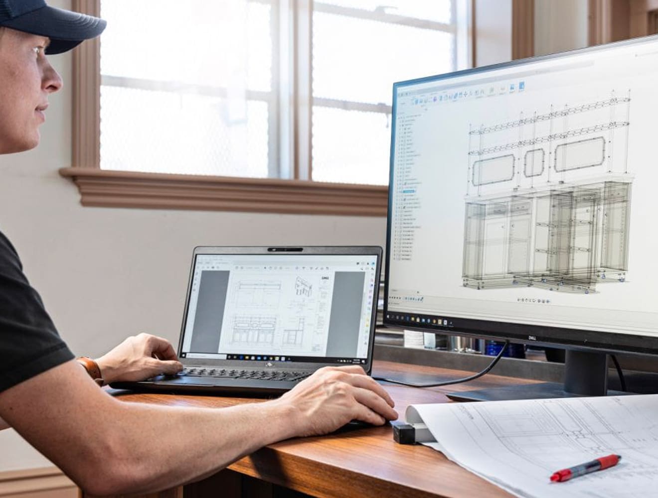 Engineering working on cabinetry in Autodesk Fusion on two screens