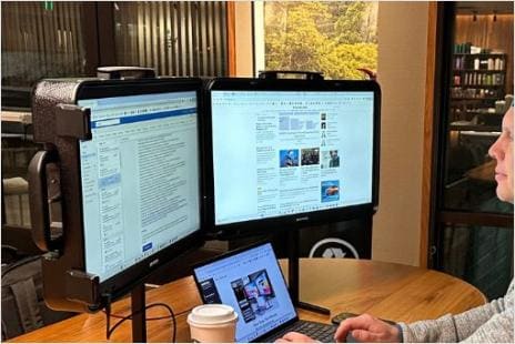 Person using Base Case dual monitors consumer product