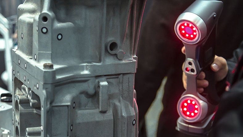 1356026547 An engineer scans a part with a 3D scanner.