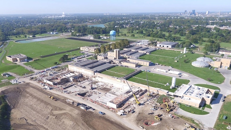 A high-angle view shows a wastewater treatment plant undergoing water infrastructure renovation.