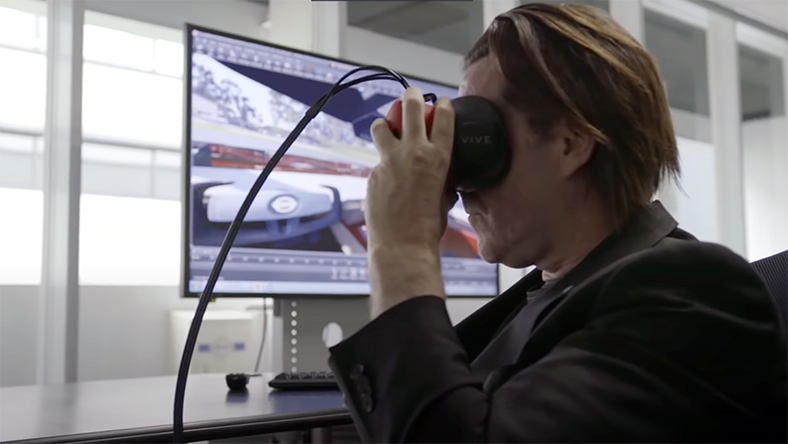 A man views a car design through AR goggles.