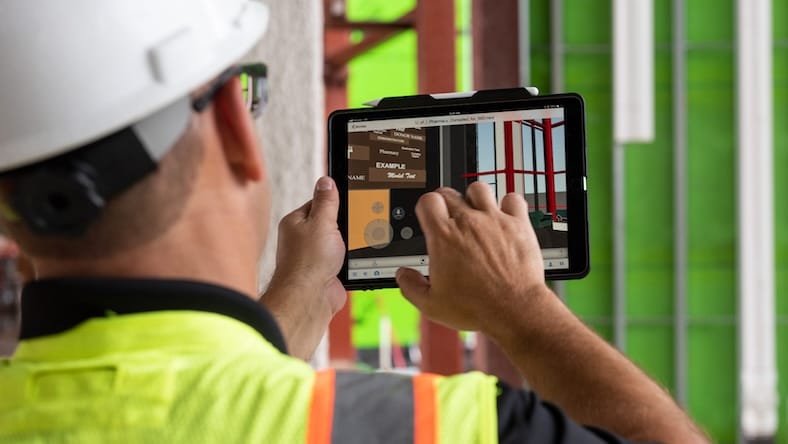 Construction project manager viewing plans on a tablet device.