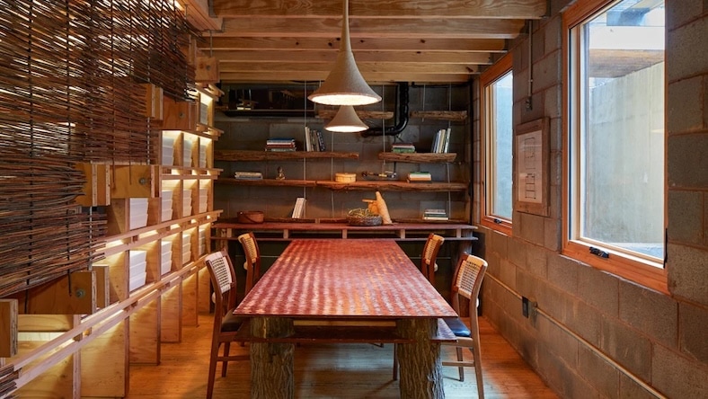 Dining room with wood floors and bookshelves.