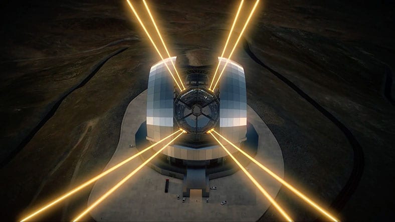 An aerial view shows a large telescope observatory emitting bright yellow laser beams into the night sky.
