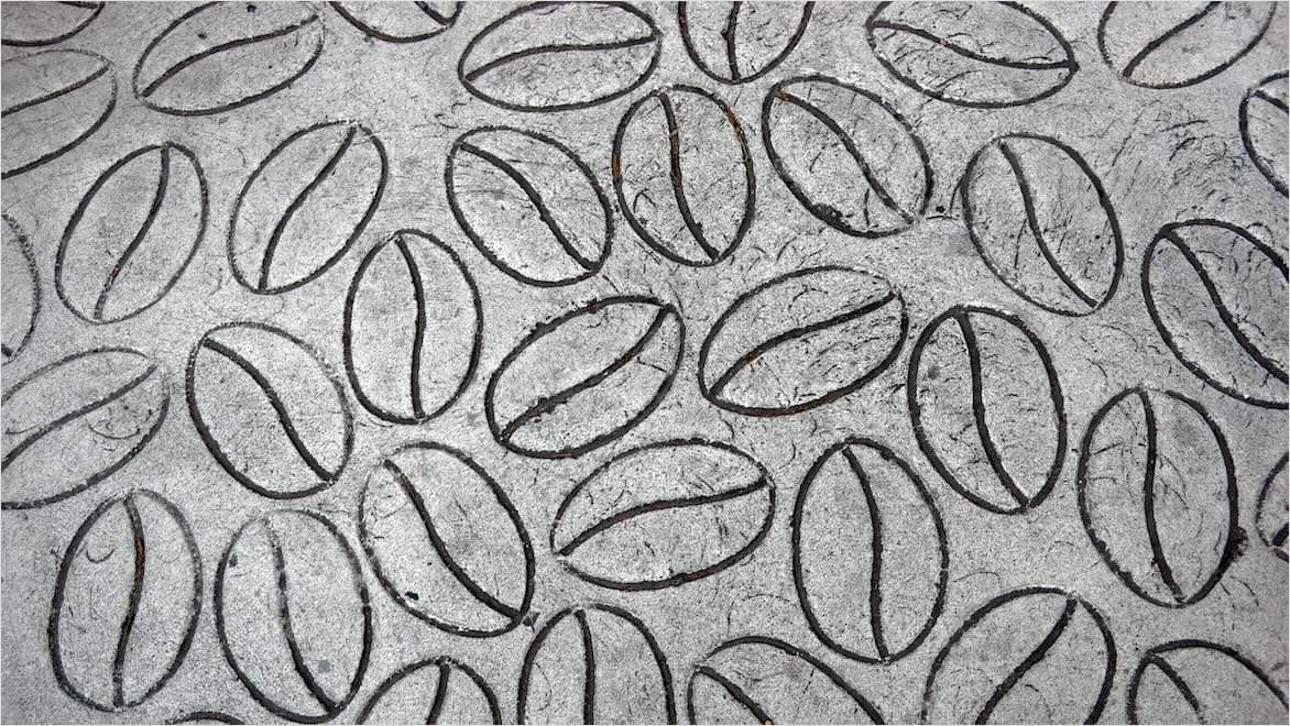  An image shows a concrete stamped with a coffee bean pattern.