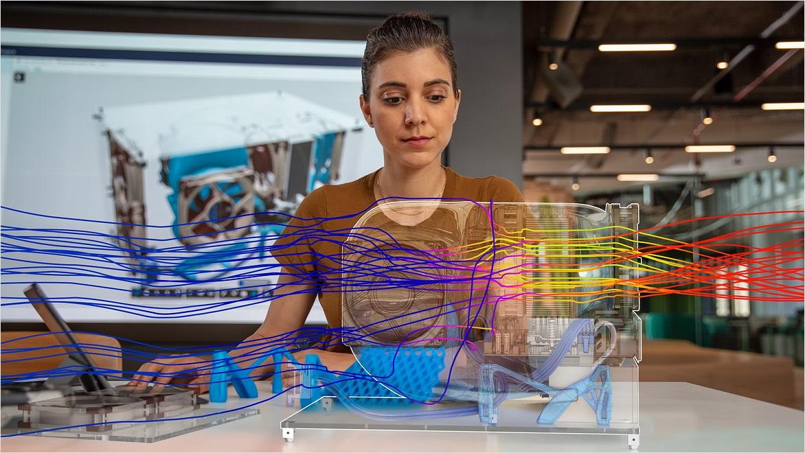 A woman appears to be viewing an overlay of a digital representation of a product simulation.