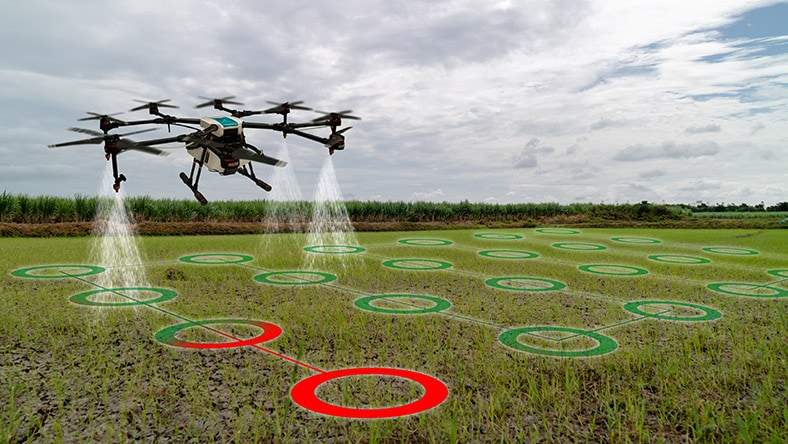 A drone surveys agricultural land.