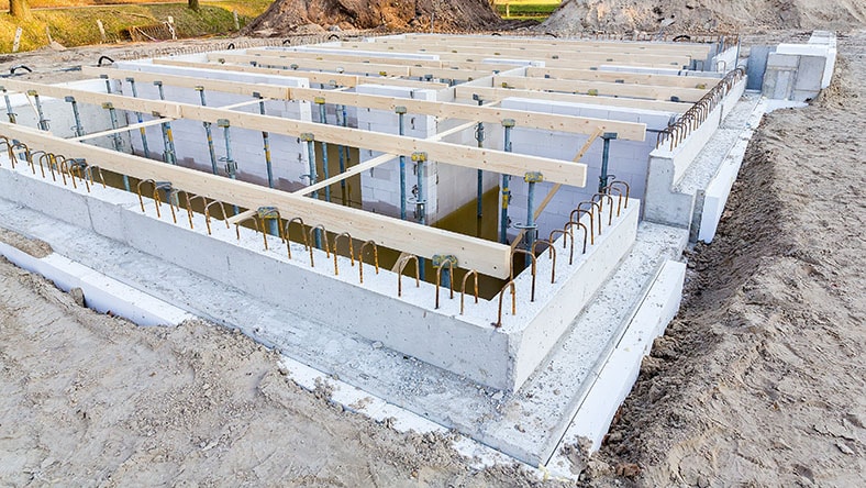 1279806553 A building foundation takes shape on a construction site.