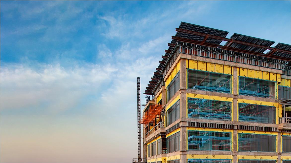 An office building under construction with overlay from design software.