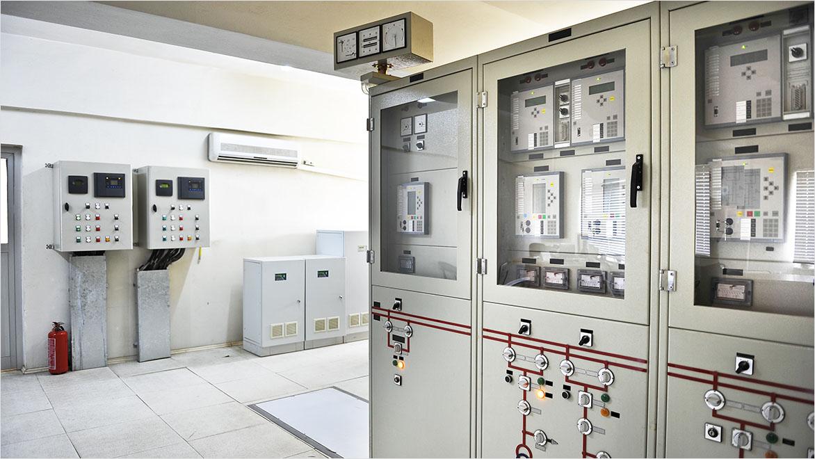 A building machine room houses electrical control systems.