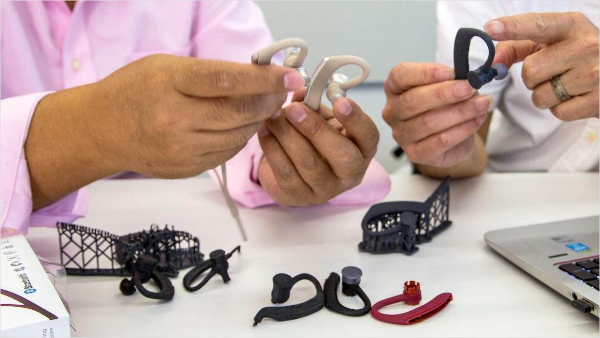 High-fidelity prototyping designers comparing 3D printed earbuds
