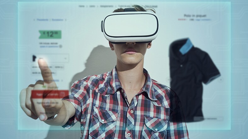 A boy wearing VR goggles browses clothing online.