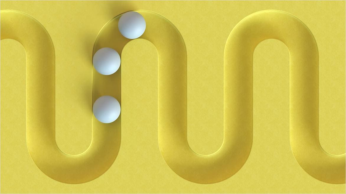 In a computer rendering, white balls follow a yellow track.