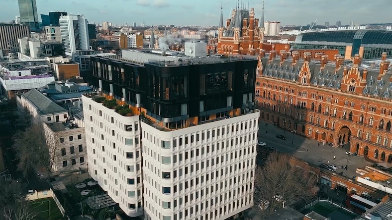 Aerial view of The Standard London, a repurposed 1970s building situated next to the Victorian Gothic St. Pancras railway station.
