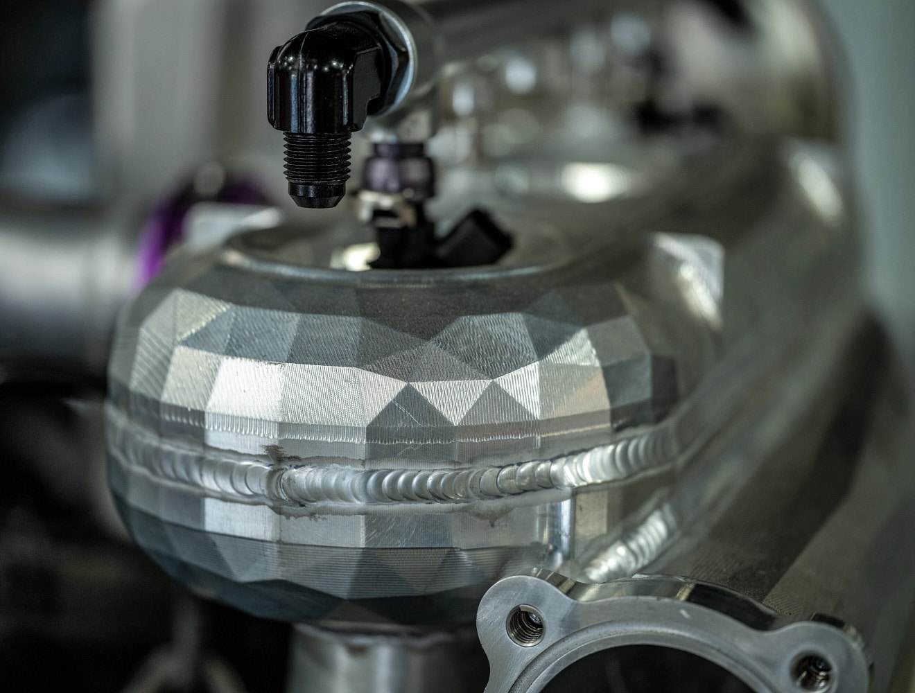 Close-up of a machined part with a faceted surface.