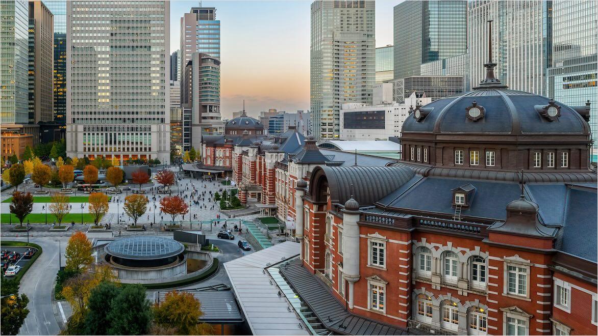 View of Tokyo’s historic Tokyo Station with modern skyline in the background.
