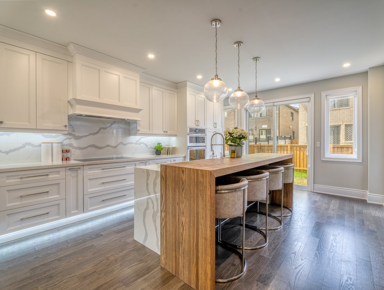 A modern suburban kitchen with cool, white task lighting.