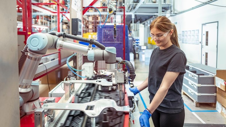 AI manufacturing worker working with cobot collaborative robot in factory