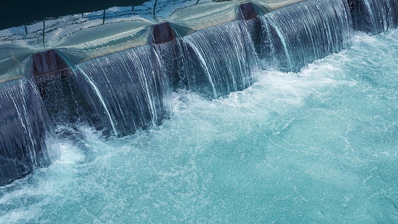 Water flows through a dam outlet.