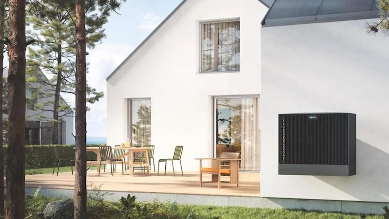 A view of a heat pump on the exterior of a modern house.