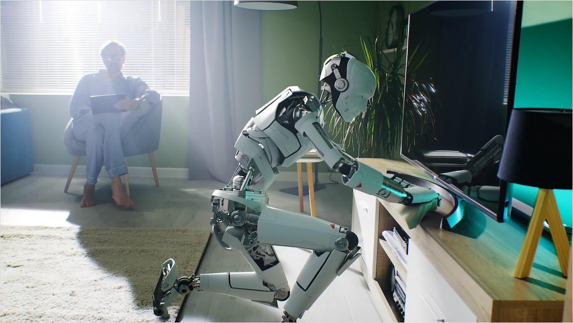 A man in pajamas sits in a chair by the window as a robot created using AI animation dusts the furniture.