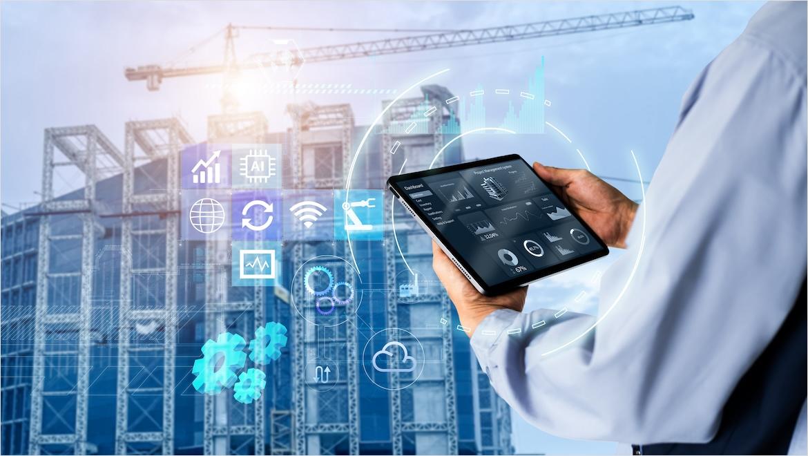 Hands use a digital tablet with construction management software on it