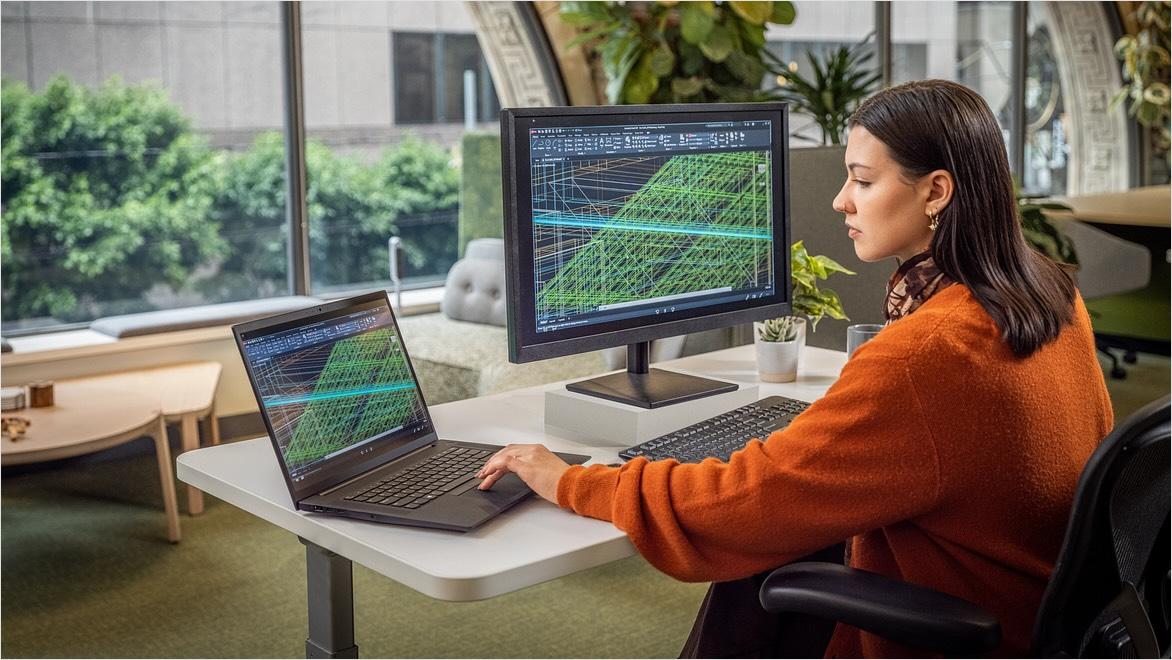 Woman using AutoCAD in an office environment