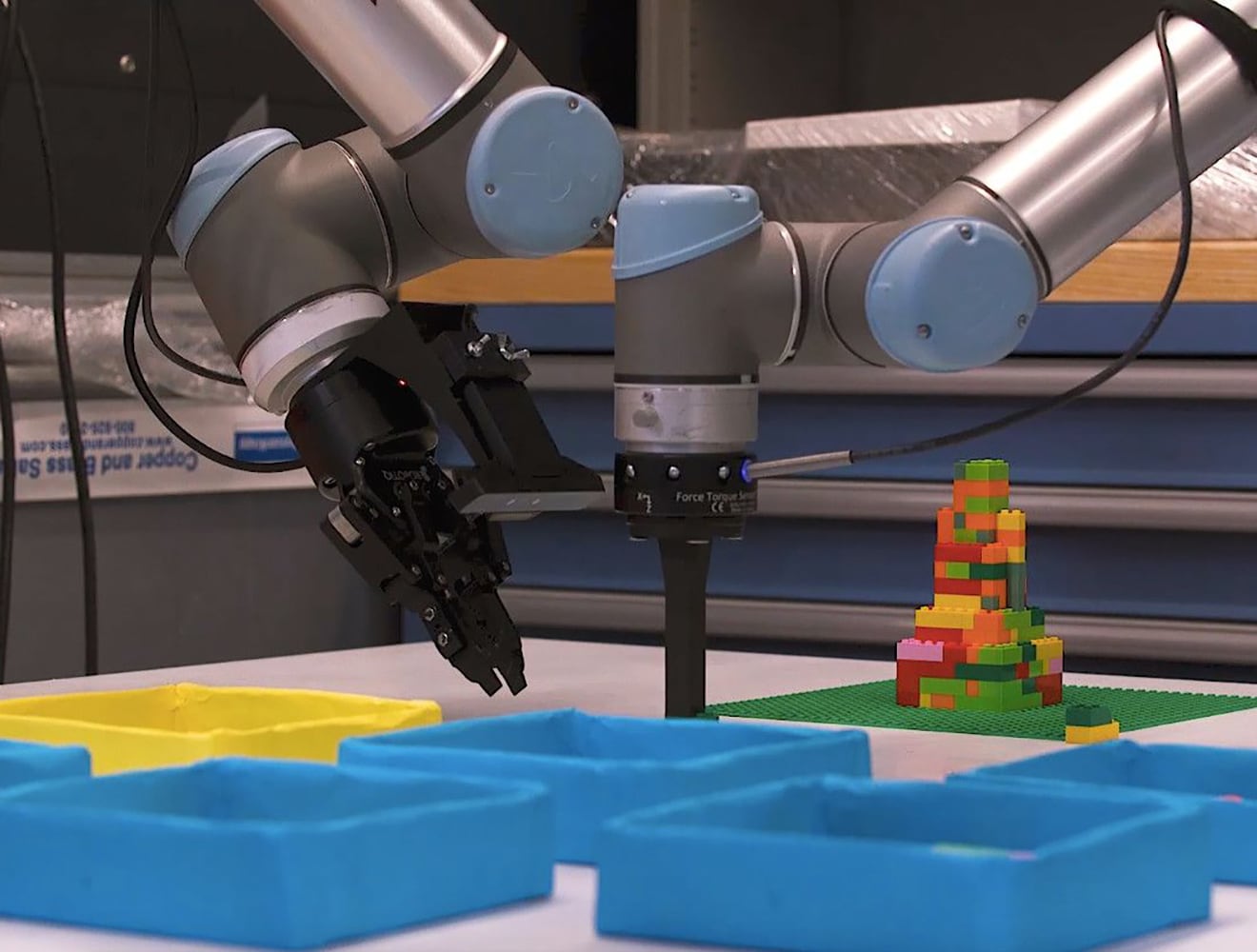 A robot places parts in a factory.