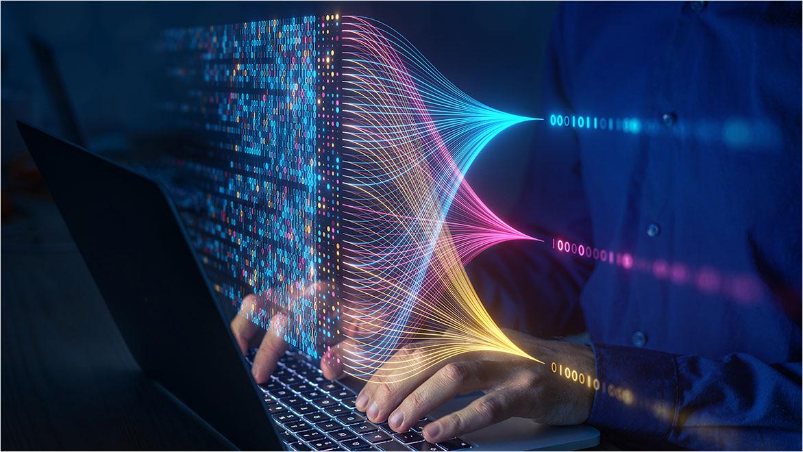 Data points are superimposed on an image of a man working on a laptop