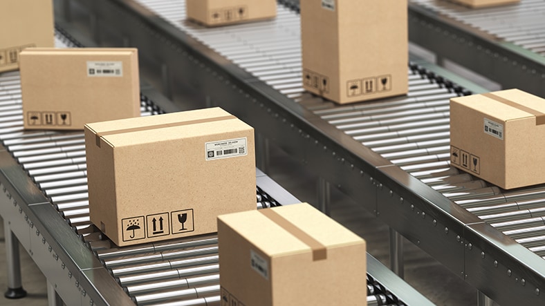 1029329040 Boxes move along a factory conveyor belt.