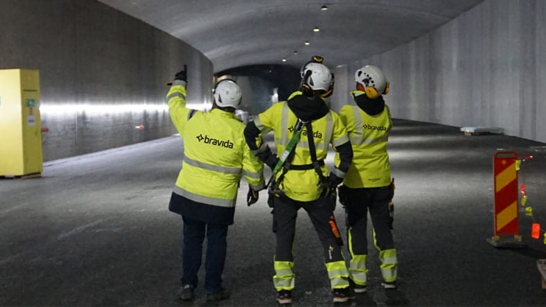 workers in lighted tunnel