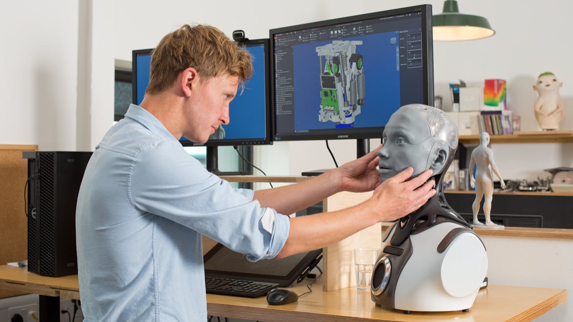 Engineered Arts Simon Osborn with the desktop version of the Ameca Humanoid Robot - Designed with Autodesk Inventor