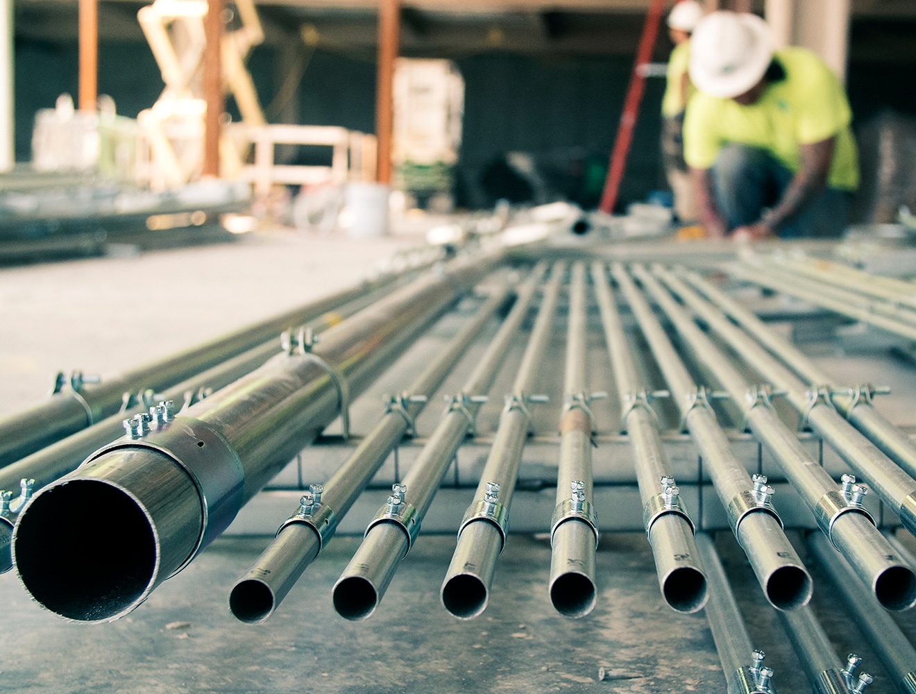 Steel pipes being inspected by building engineering professional