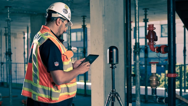 Man at a construction site using a reality capture scanning device