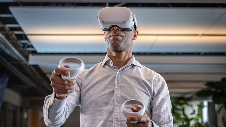 Person wearing Meta Quest glasses and holding controllers