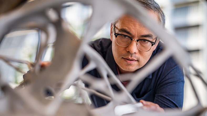 Engineer standing behind 3D-model