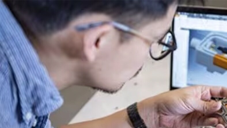 Designer looking at a model