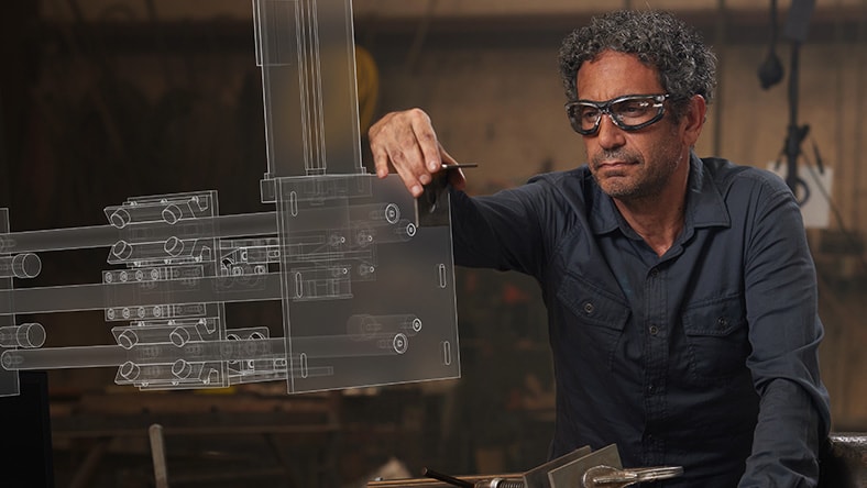 Designer inspecting machine part